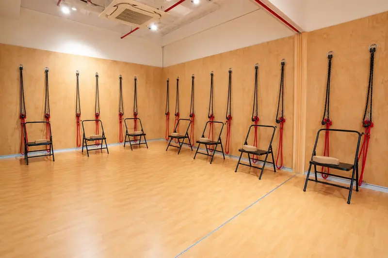Open studio floor with chairs along a wooden wall